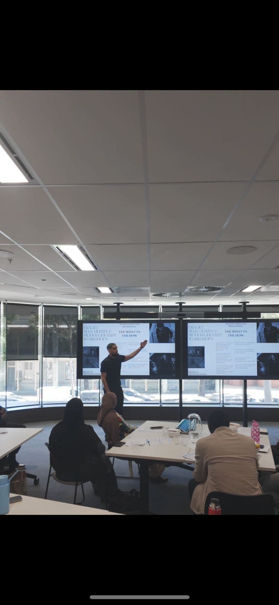 A workshop presenter addressing a room of students